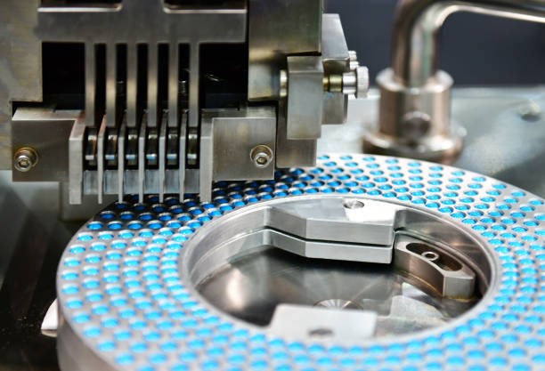 Blue capsule medicine pill production line, Industrial pharmaceutical concept.